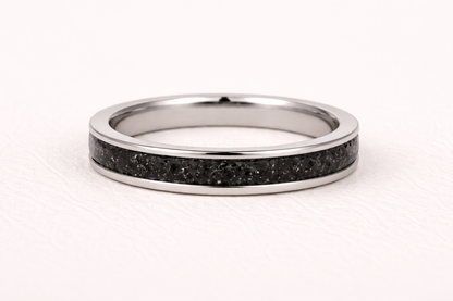 Silver ring with black inlay on a white background