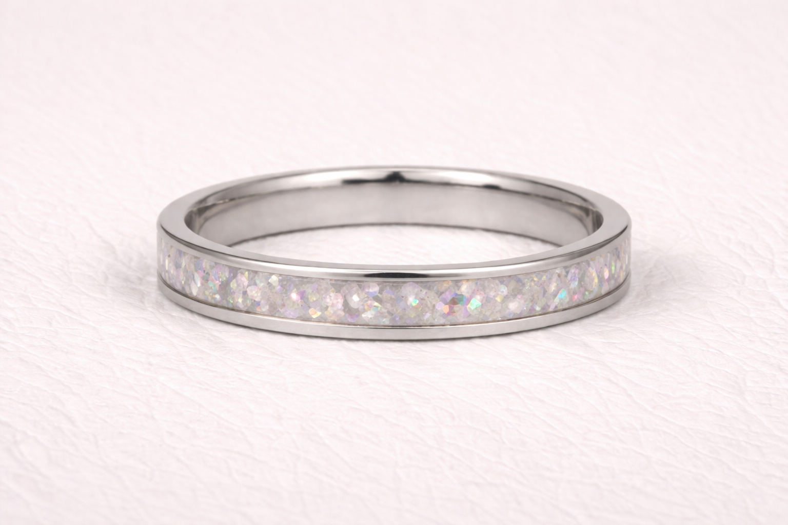 Shimmering ring placed on soft textured fabric surface