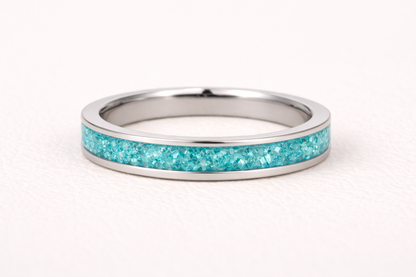 Silver ring with turquoise inlay on a white background